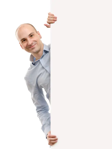 Smiling handsome man posing behind a billboard — Stock Photo, Image