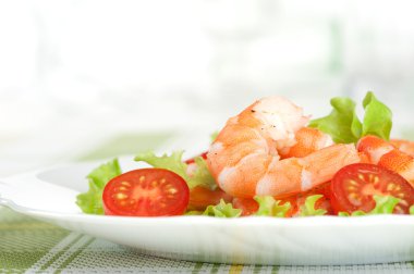 Salad of king prawns and vegetables on a plate clipart