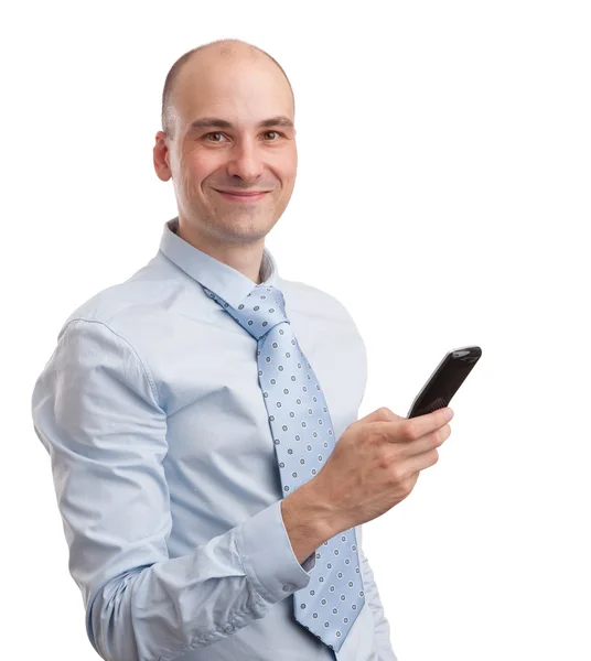 Młody biznesmen uśmiechający się z telefonem komórkowym — Zdjęcie stockowe