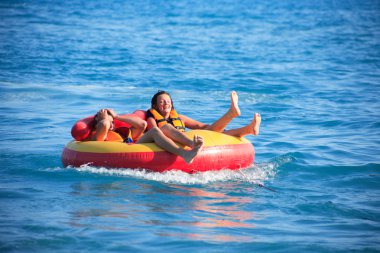 Friends Tubing On Sea clipart