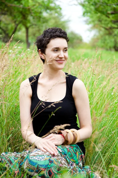 Taze bahar çimlerde oturan kız — Stok fotoğraf