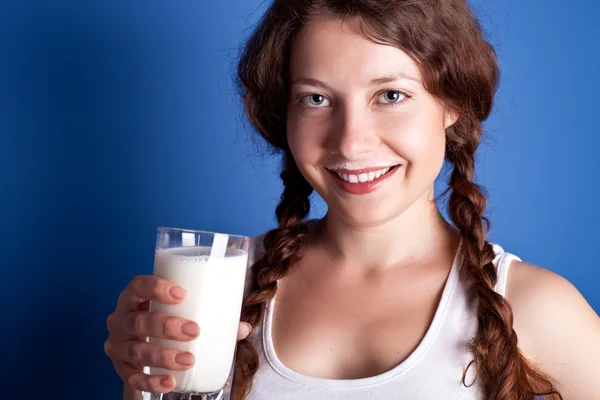 Woman enjoying a glass milk — Stockfoto