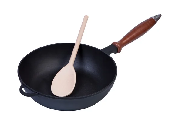 Frying pan with a wooden spoon inside. — Stock Photo, Image