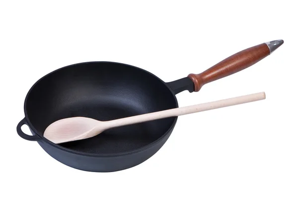 Frying pan with a wooden spoon. — Stock Photo, Image