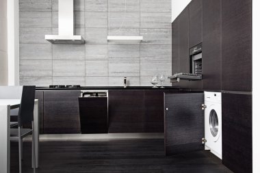 Part of black hardwood kitchen with build-in domestic technique clipart