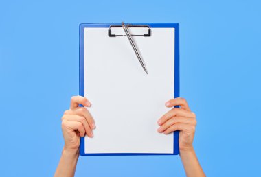 Clipboard in female hands on blue background clipart