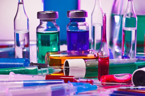 Medical laboratory glass equipment still life on blue purple — Stock Photo, Image