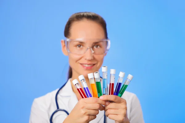 Medical test tubes with fluid sample closeup in doctor hand on b — Stock Photo, Image