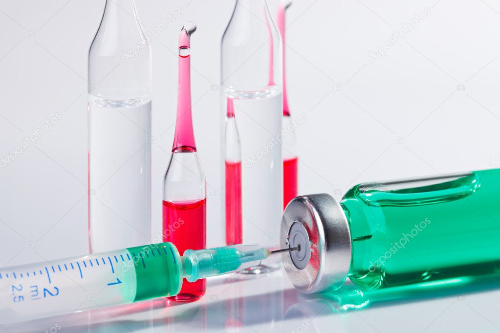 Injection preparation with ampoule and syringe on white
