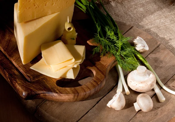 El queso con la verdura y las setas a la tabla de madera — Foto de Stock