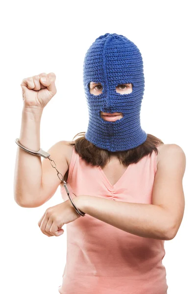 Woman in balaclava showing handcuffs on hands — Stock Photo, Image