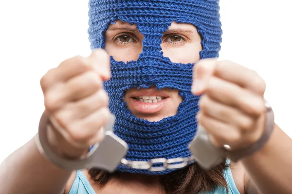 Woman in balaclava showing handcuffs on hands — Stock Photo, Image