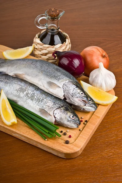 Fresh raw fish trout on a wooden board — Stock Photo, Image