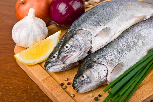 Fresh raw fish trout with vegetables — Stock Photo, Image