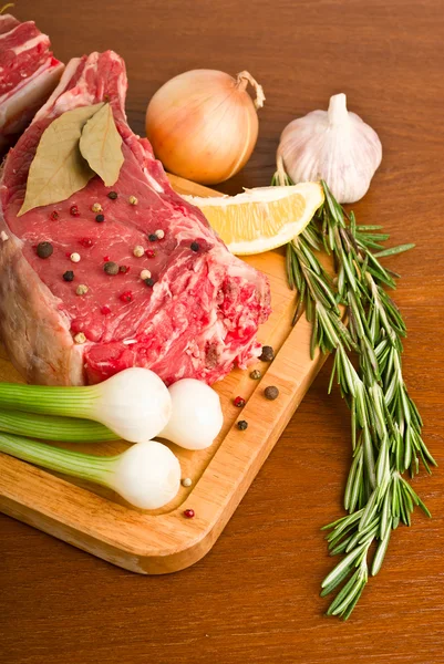 Raw meat with rosemary — Stock Photo, Image