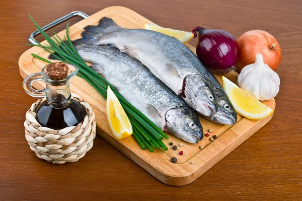 Fresh raw fish trout on wooden board — Stock Photo, Image