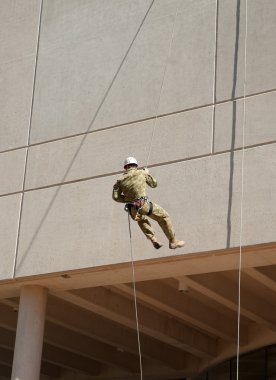Abseiling down the wall clipart