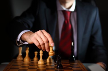 Businessman playing chess clipart