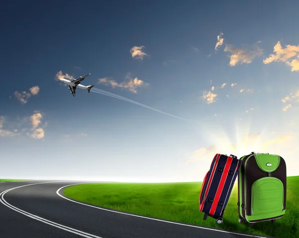 Red suitcase and plane — Stock Photo, Image