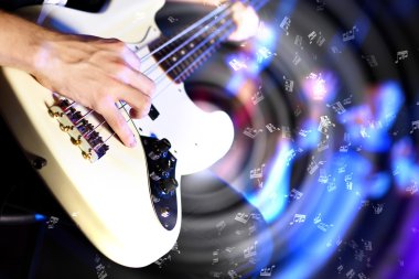 Young guitar player performing in night club clipart