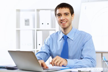 Young businessman in the office clipart