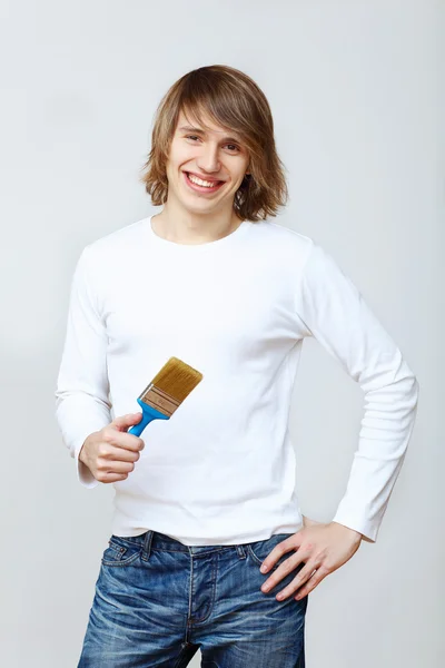 Man with paint brushes — Stock Photo, Image