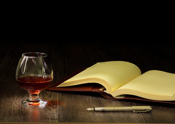 stock image Cognac, cigar and an old book nearby