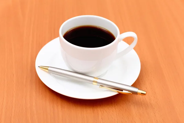 Café preto em uma xícara e caneta — Fotografia de Stock