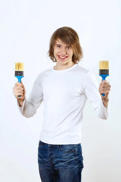 Man with paint brushes — Stock Photo, Image