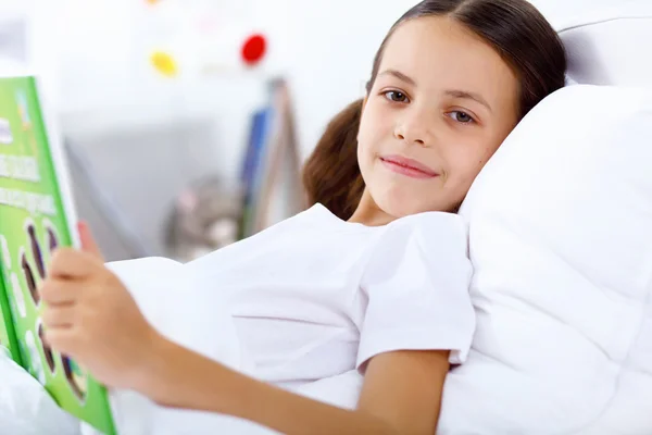 stock image Girl with a book in bed at home