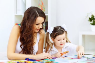 Mother and daughter studying clipart