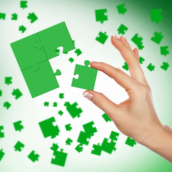 Puzzle pieces and human hand — Stock Photo, Image