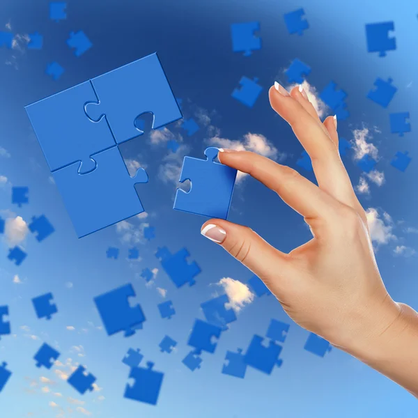 Puzzle pieces and human hand — Stock Photo, Image