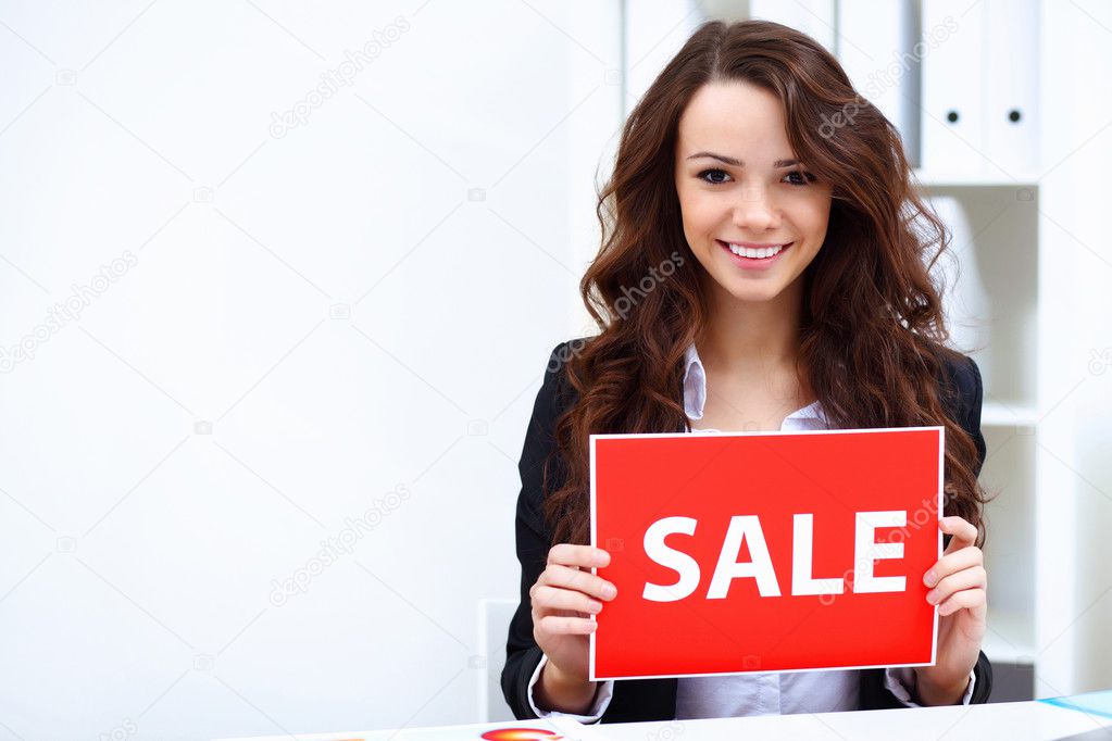 Young business woman with sale sign
