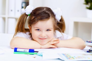 Little girl and her mother studying clipart