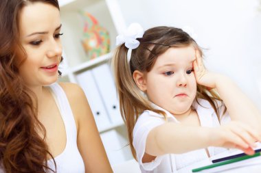 Mother and daughter studying clipart