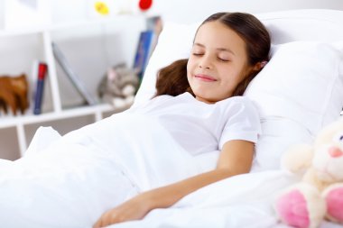 Girl sleeping in bed at home clipart