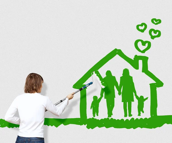 Family and home symbol on the wall — Stock Photo, Image