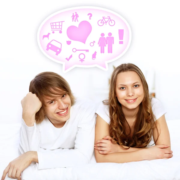 Young couple in white with heart symbols — Stock Photo, Image