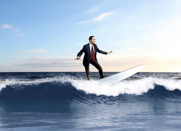 Young business person surfing on the waves — Stock Photo, Image