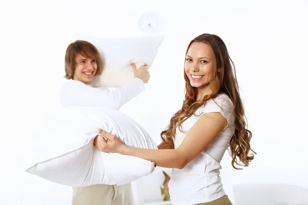 Молода пара бореться з подушками — стокове фото