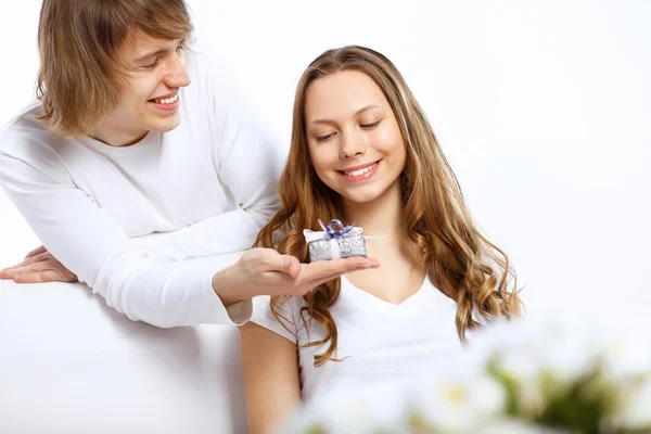 Young couple at home with present — Stock Photo, Image