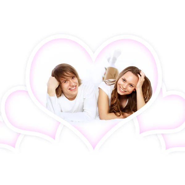 Young couple in white with heart symbols — Stock Photo, Image