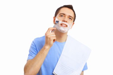 Young man at home shaving himself clipart