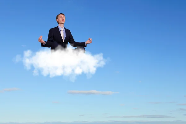 Uomo d'affari che medita seduto sulla nuvola — Foto Stock