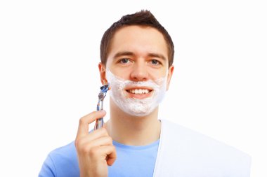 Young man at home shaving himself clipart