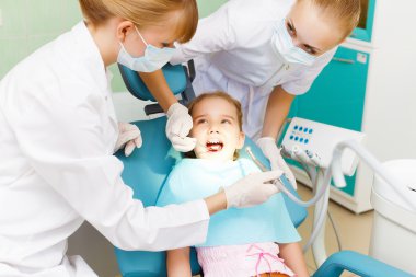 Little girl visiting dentist clipart