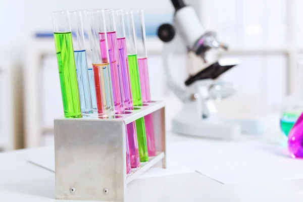 Chemistry laboratory glassware with colour liquids — Stock Photo, Image