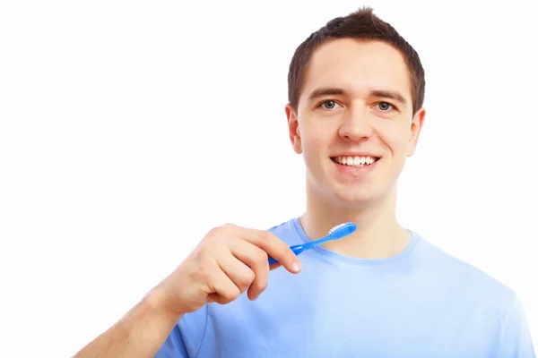 Νεαρός άνδρας στο σπίτι βούρτσισμα των δοντιών — Φωτογραφία Αρχείου