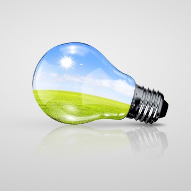 Electric light bulb and blue sky inside it clipart